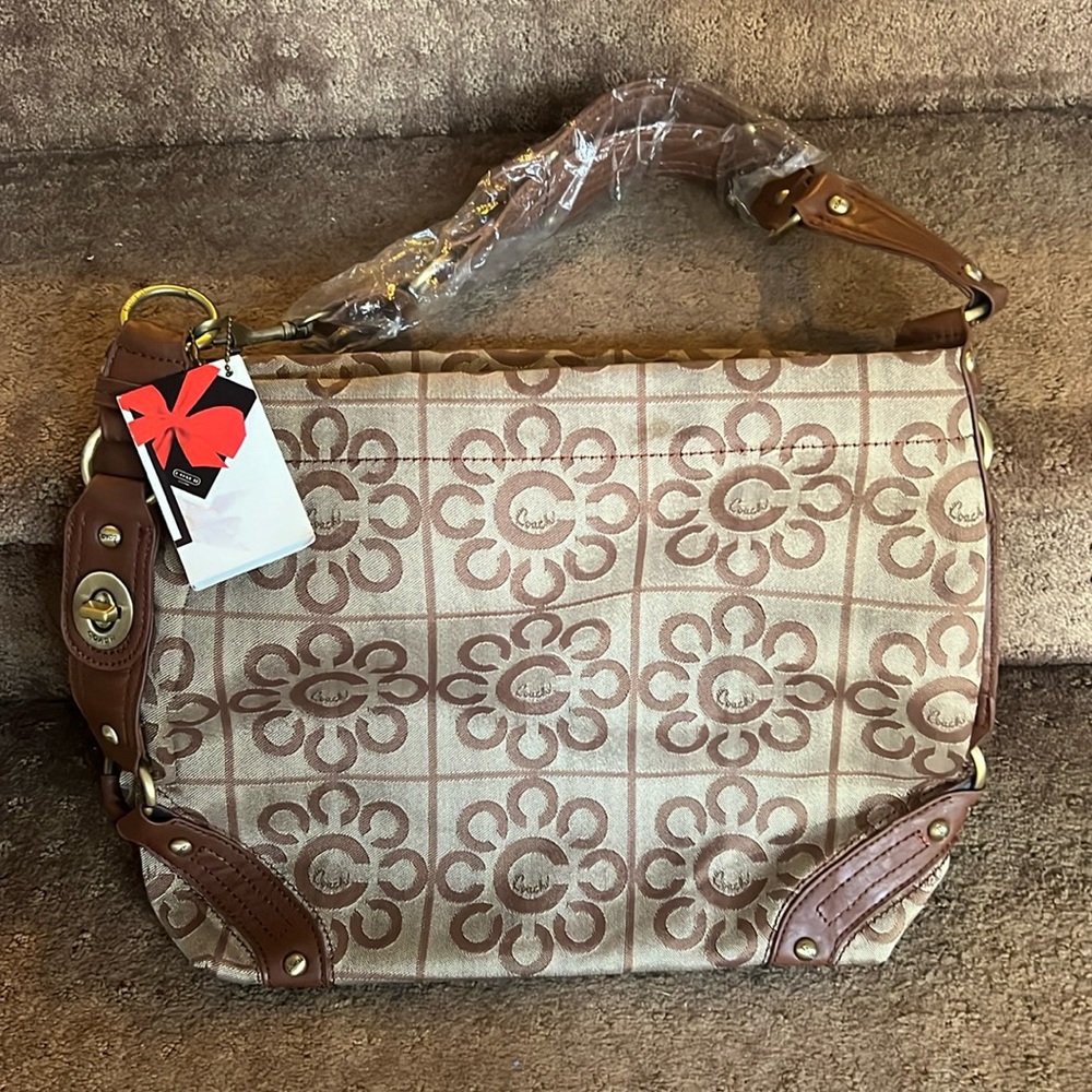 Brand new Coach purse with plastic on strap and original Coach tag